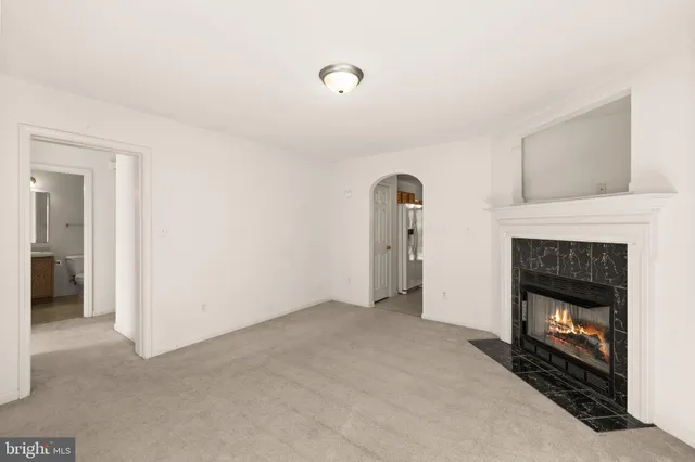 a view of an empty room with a fireplace