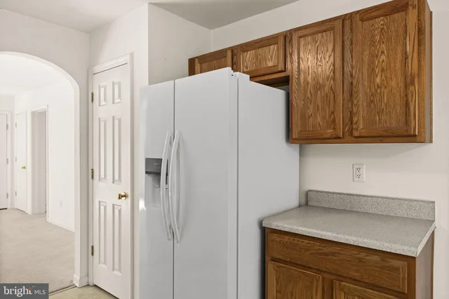 a kitchen with a refrigerator and cabinets