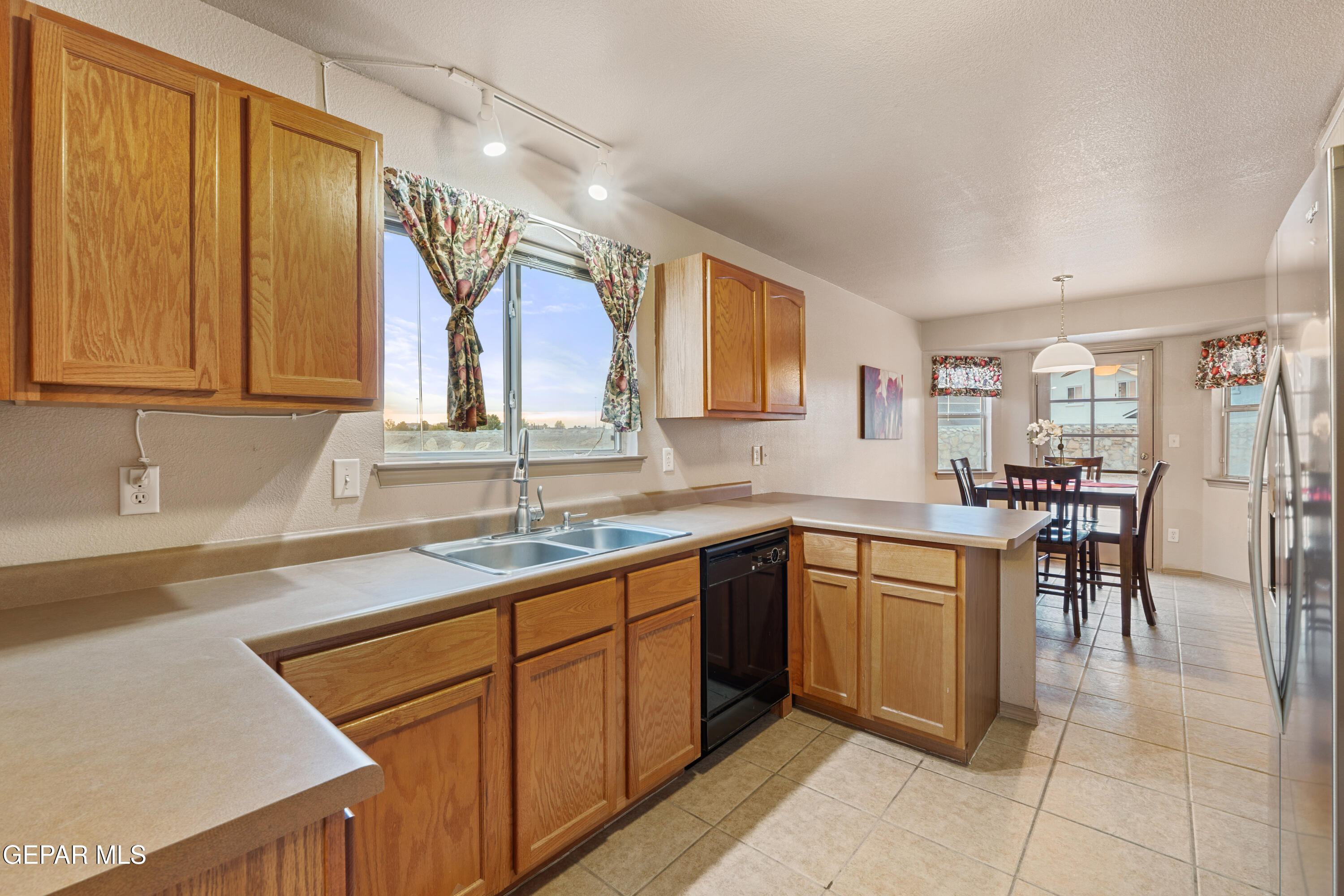 3849 Tierra Roca Place El Paso, TX 79938 - Photo 13 of 44 a kitchen with a sink and cabinets