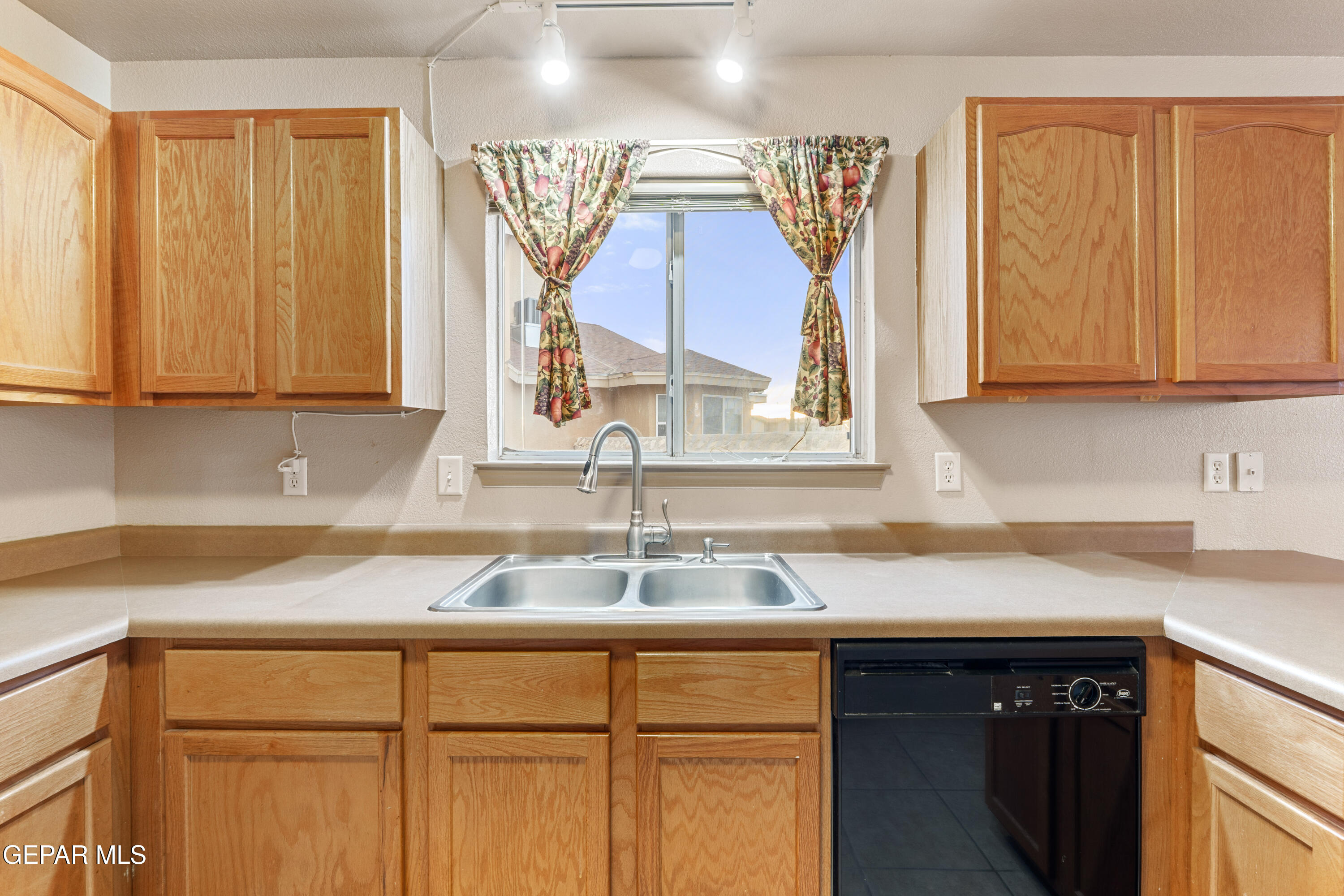 3849 Tierra Roca Place El Paso, TX 79938 - Photo 14 of 44 a kitchen with a sink cabinets and a window