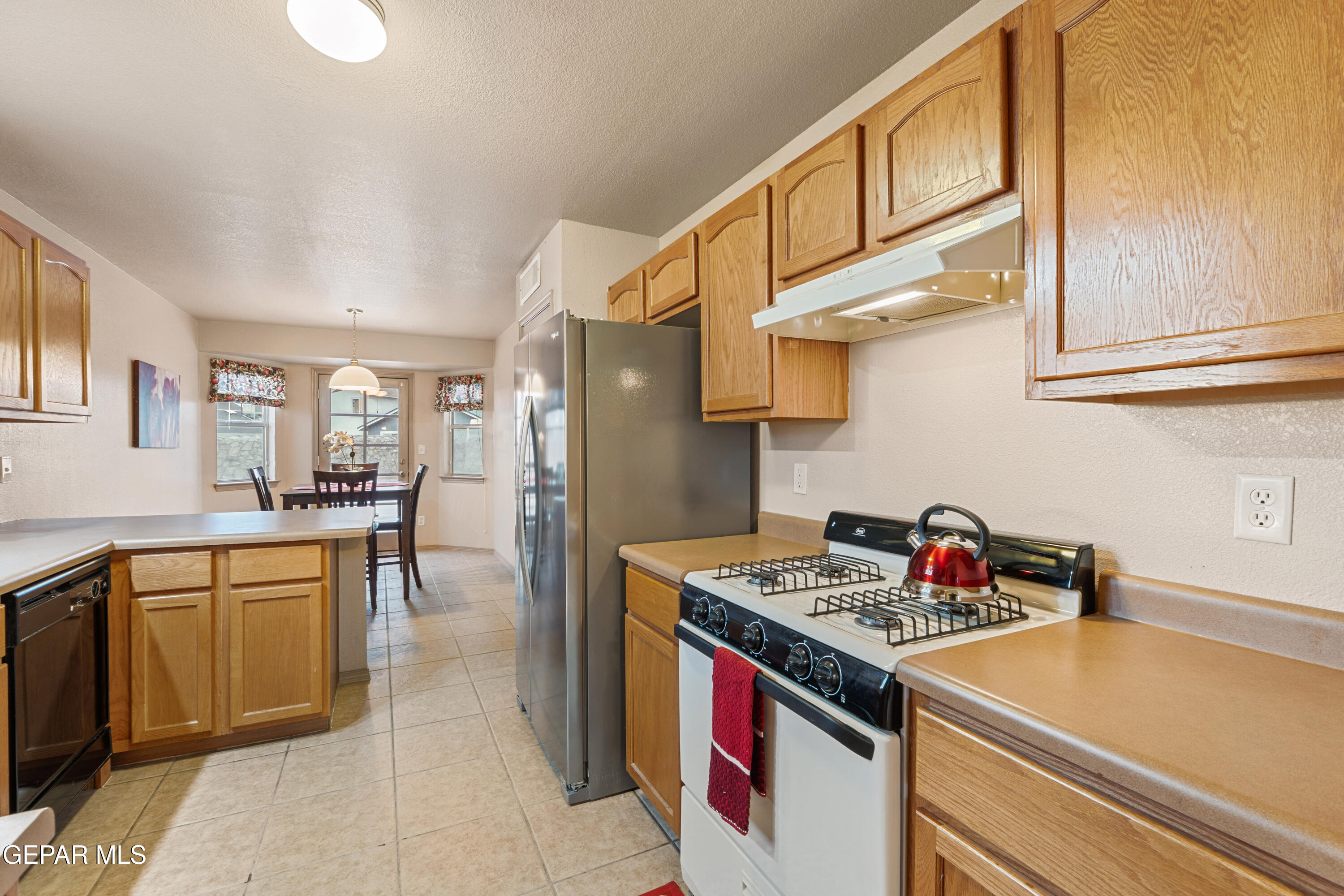 3849 Tierra Roca Place El Paso, TX 79938 - Photo 15 of 44 a kitchen with stainless steel appliances granite countertop a sink and cabinets