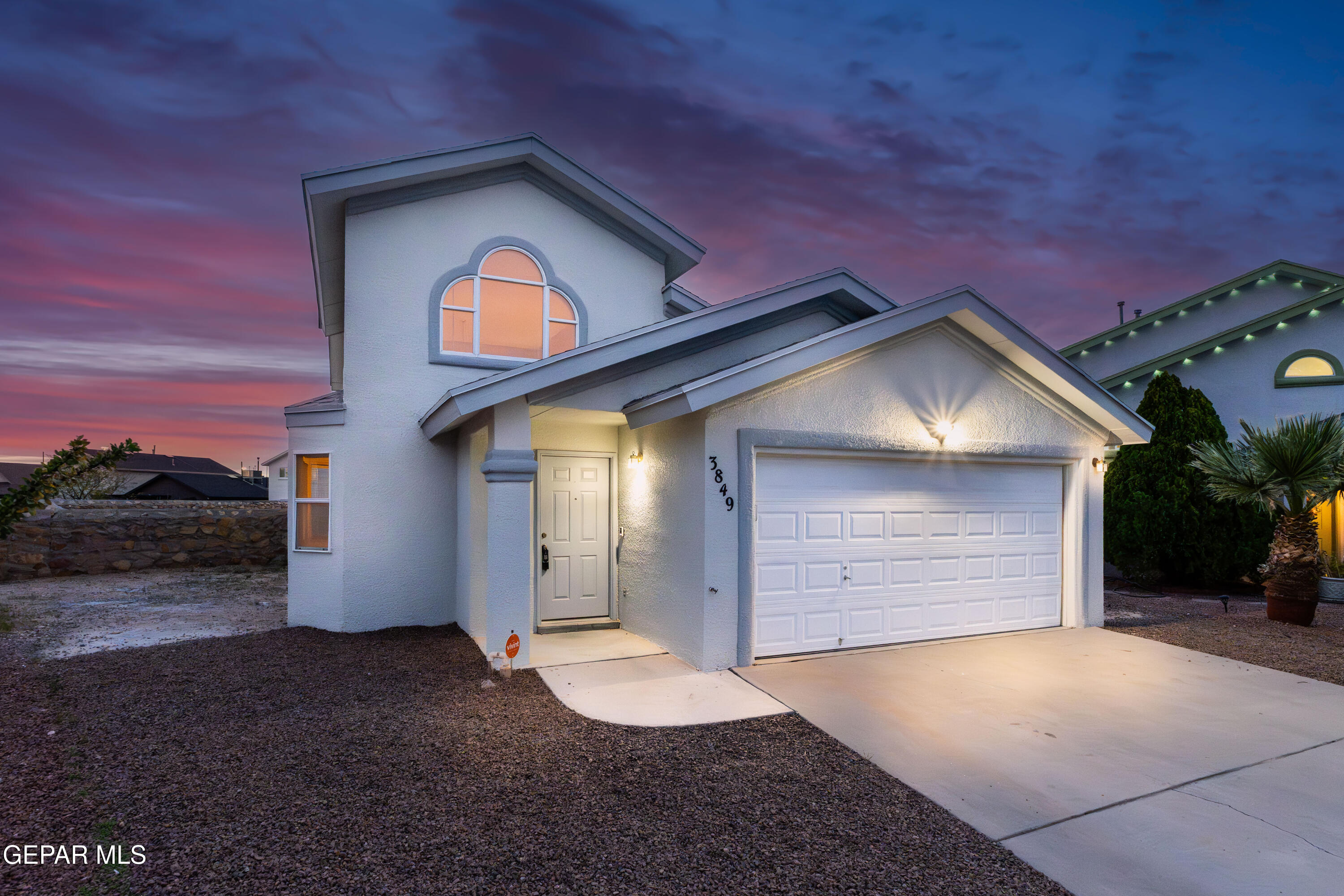 3849 Tierra Roca Place El Paso, TX 79938 - Photo 2 of 44 a view of a house with a yard and garage