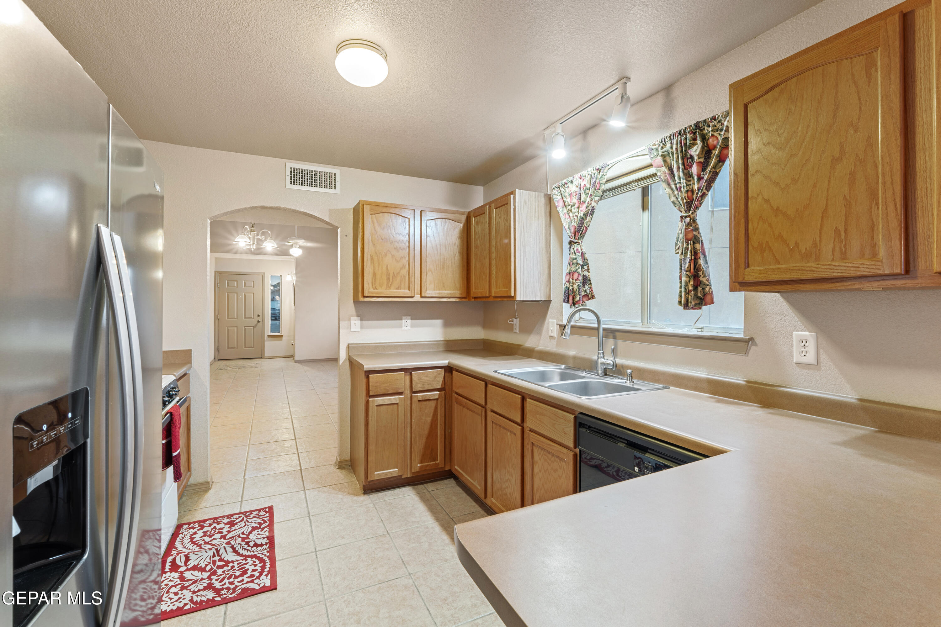 3849 Tierra Roca Place El Paso, TX 79938 - Photo 21 of 44 a kitchen with stainless steel appliances granite countertop a sink and a refrigerator