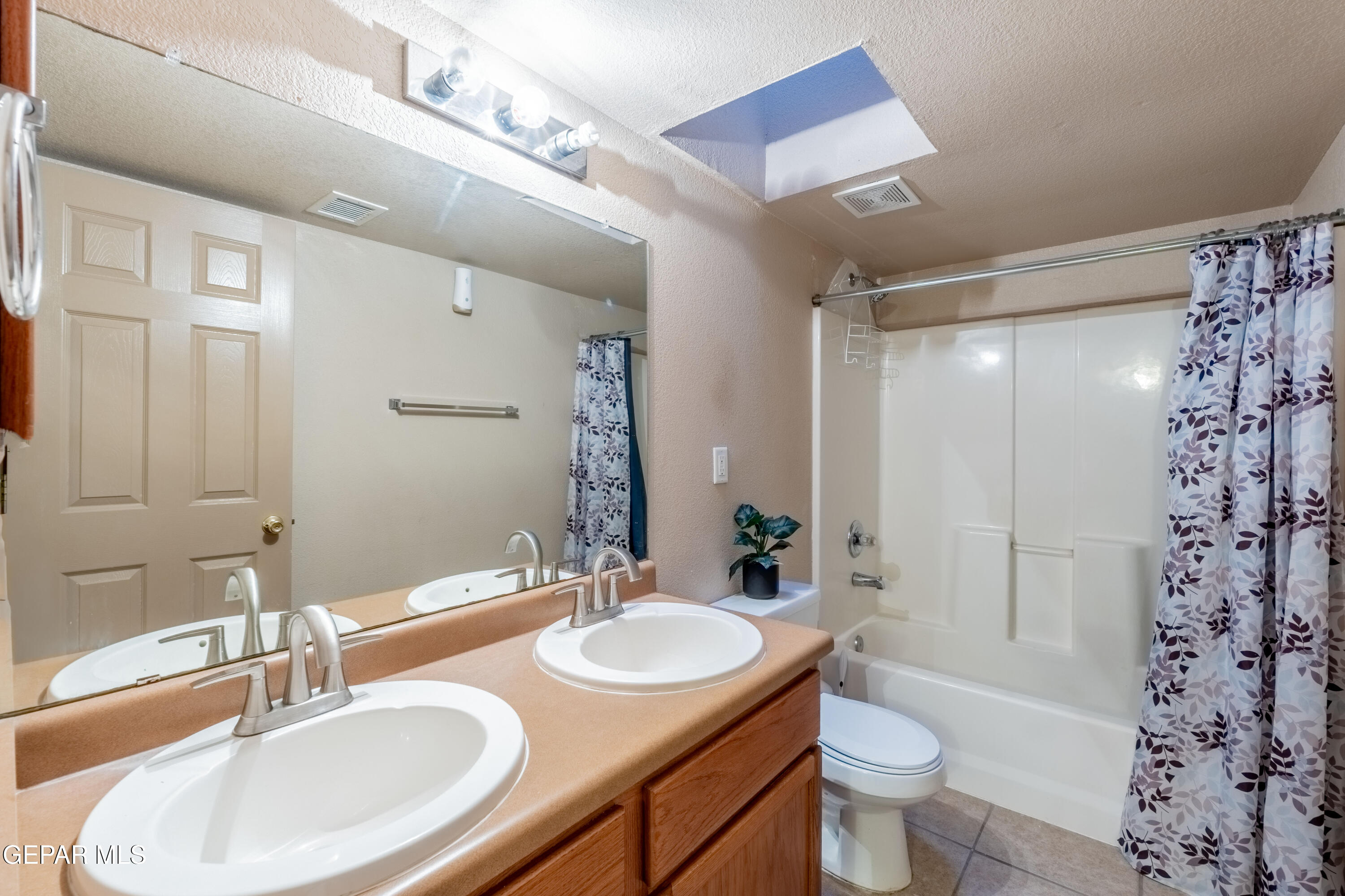 3849 Tierra Roca Place El Paso, TX 79938 - Photo 23 of 44 a bathroom with a granite countertop sink toilet and shower