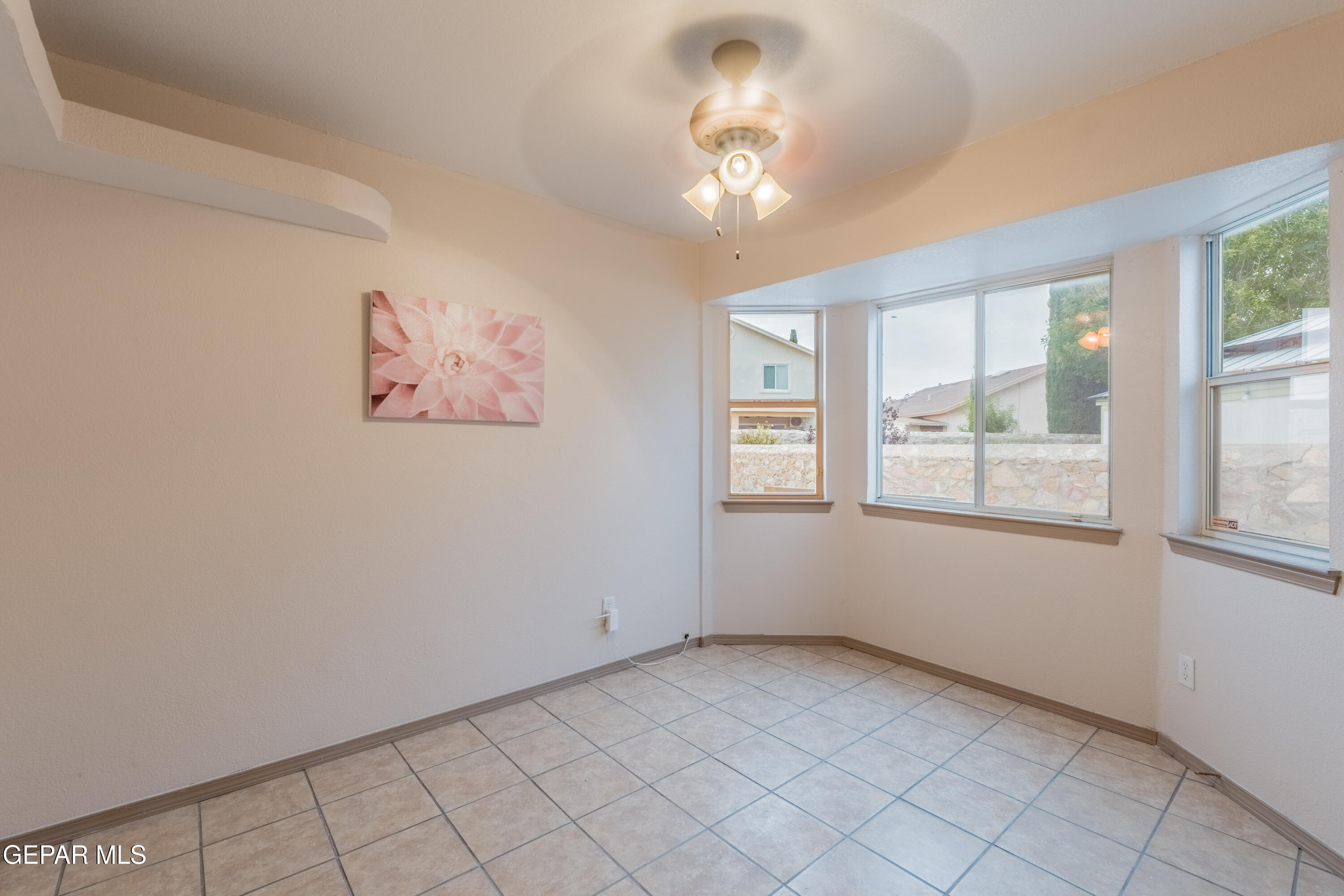 3849 Tierra Roca Place El Paso, TX 79938 - Photo 24 of 44 an empty room with windows and fan