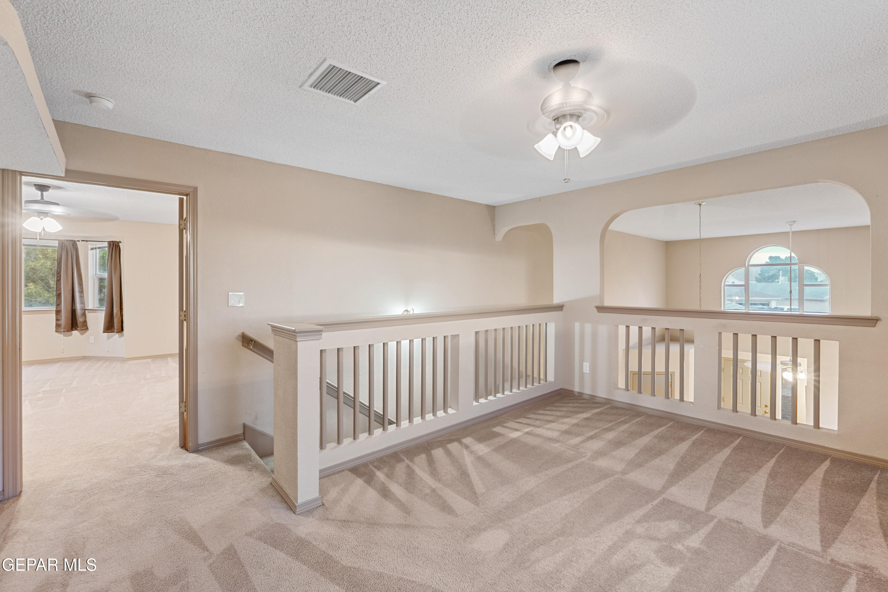 3849 Tierra Roca Place El Paso, TX 79938 - Photo 29 of 44 a view of staircase with white walls and chandelier