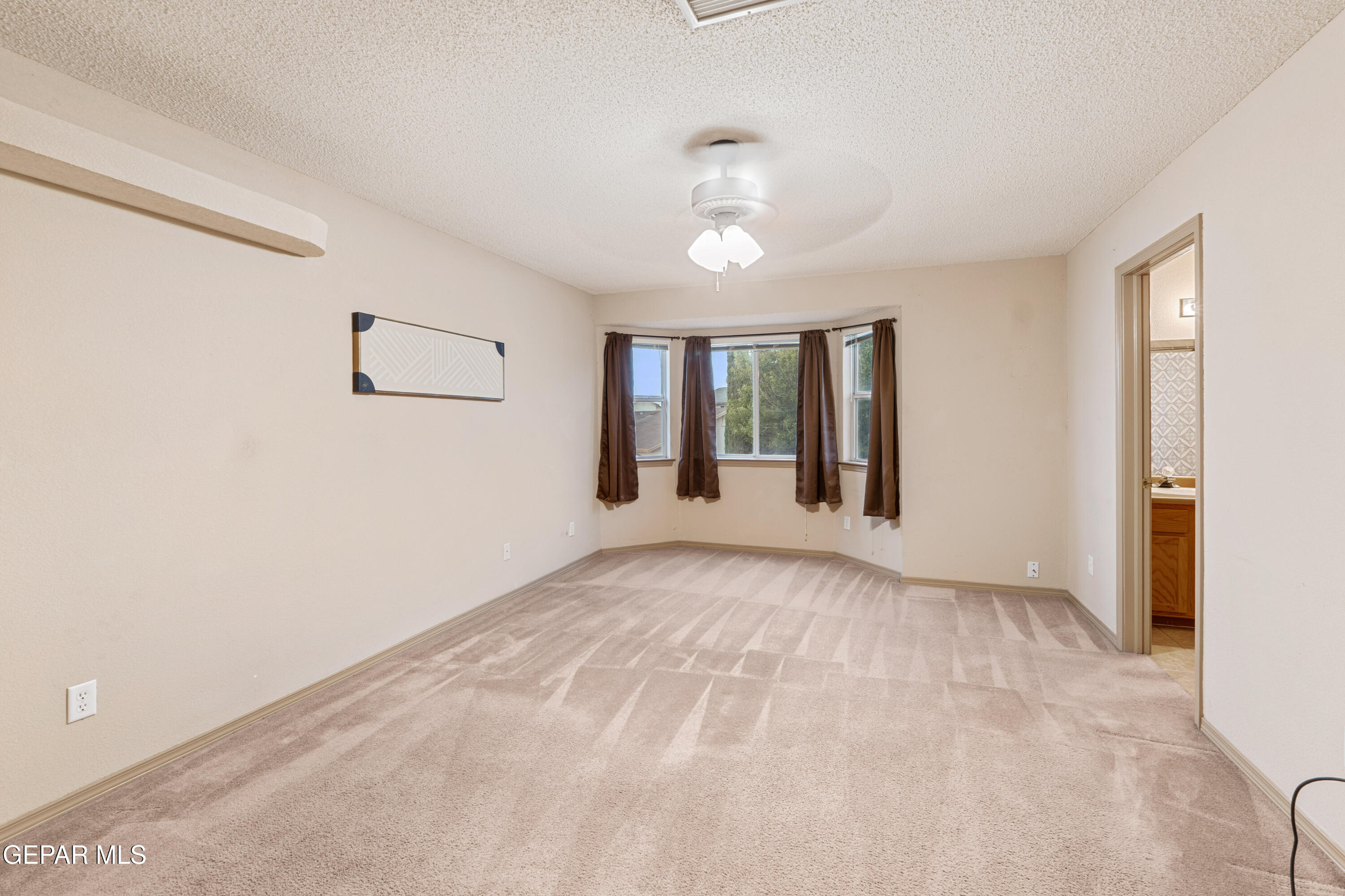 3849 Tierra Roca Place El Paso, TX 79938 - Photo 33 of 44 a view of an empty room with window and wooden floor