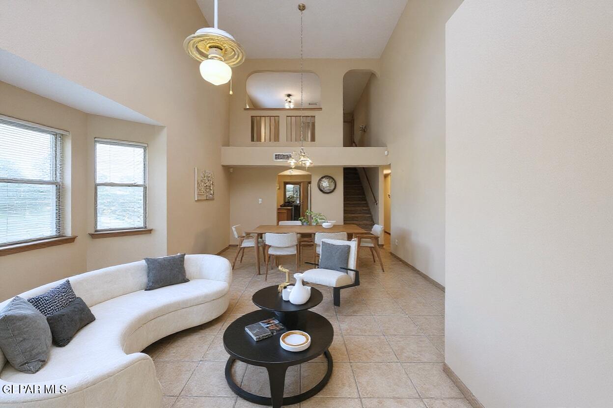 3849 Tierra Roca Place El Paso, TX 79938 - Photo 4 of 44 a living room with furniture a chandelier and a large window