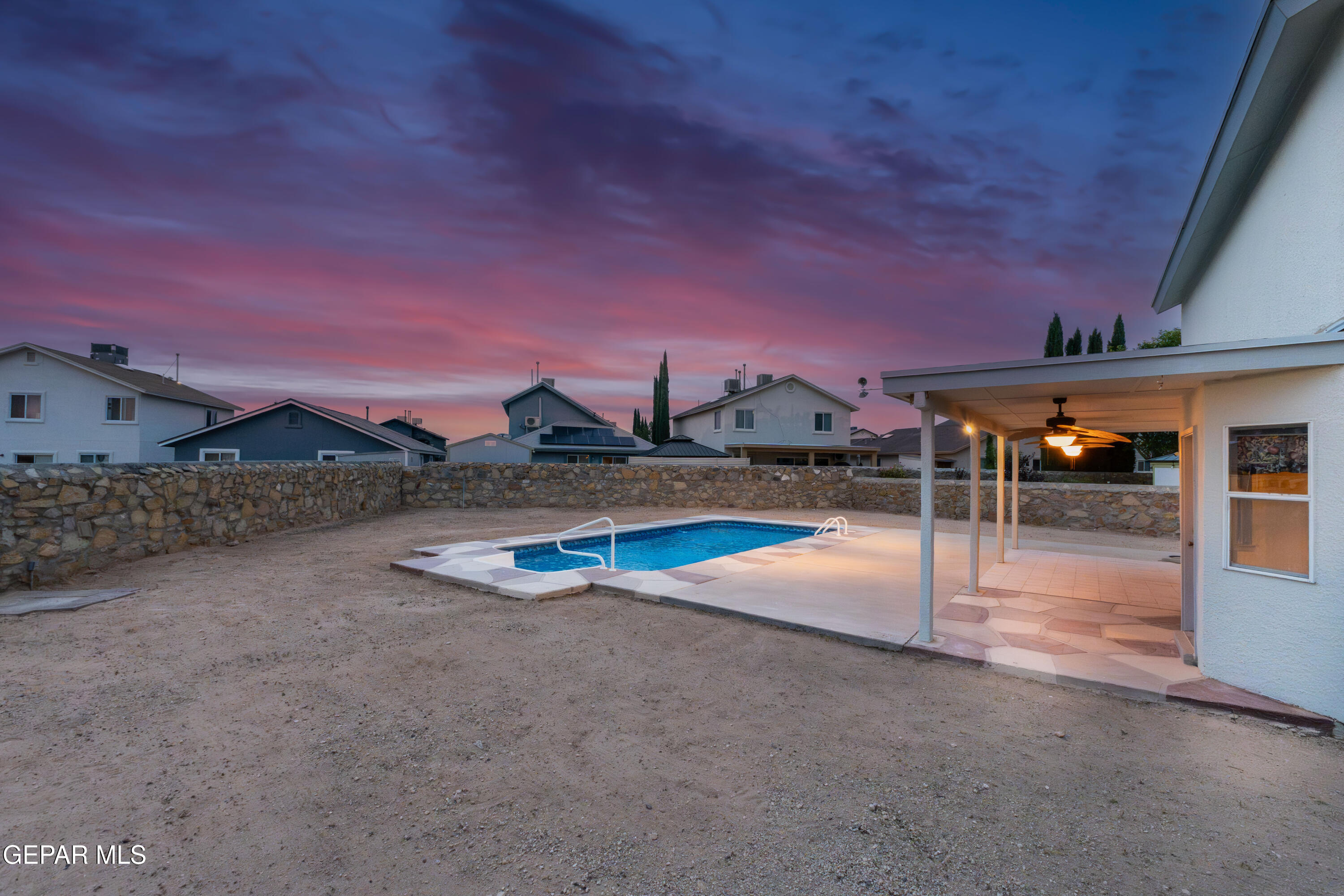 3849 Tierra Roca Place El Paso, TX 79938 - Photo 41 of 44 a view of a swimming pool with a table and chairs