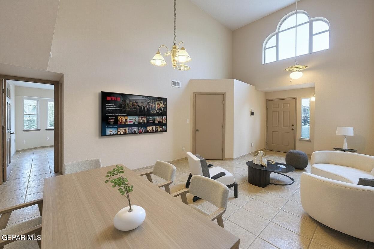 3849 Tierra Roca Place El Paso, TX 79938 - Photo 9 of 44 a living room with furniture a chandelier and a flat screen tv