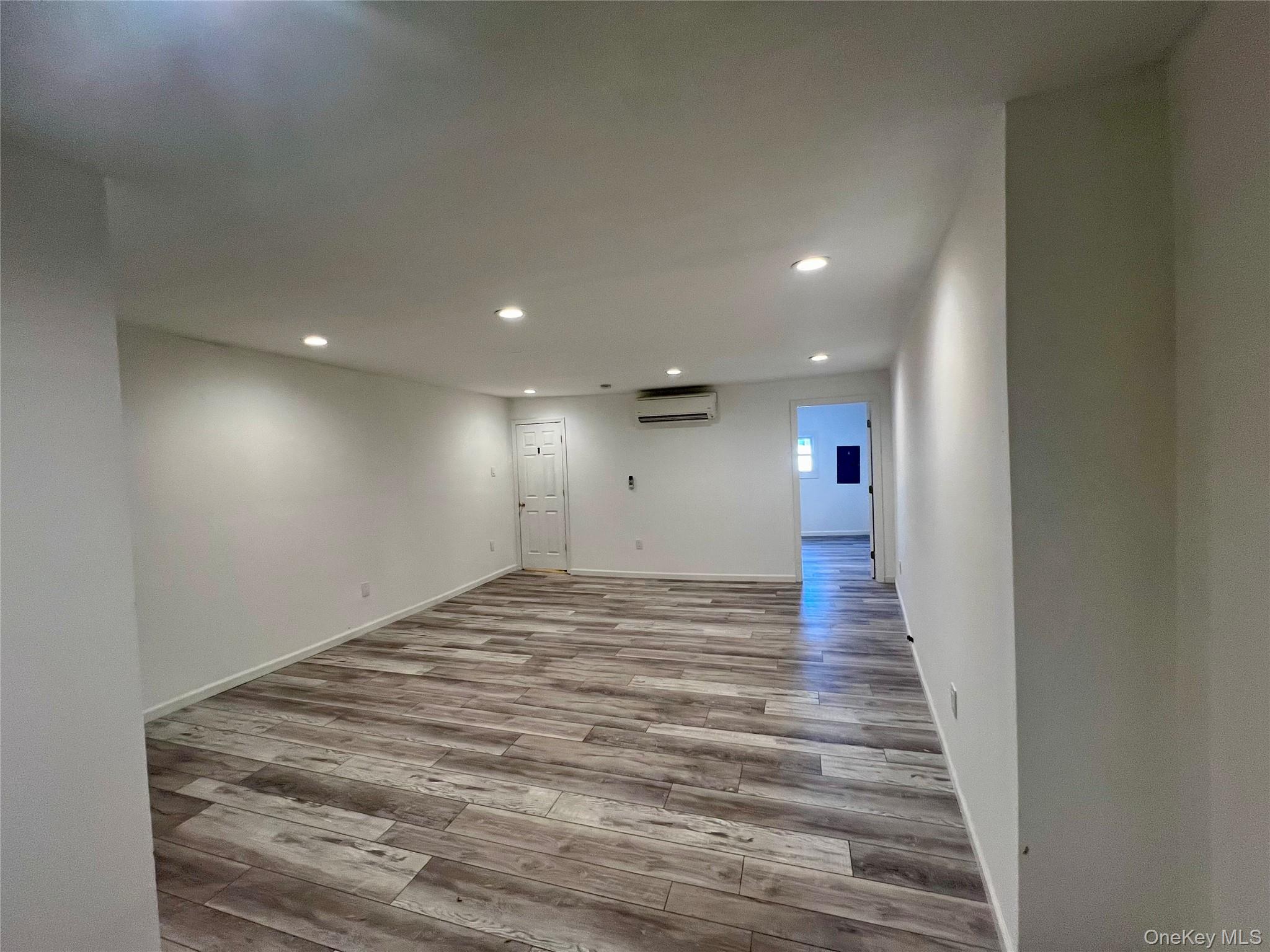 356 Main Street, Unit 1 Farmingdale, NY 11735 - Photo 4 of 4 a view of a hallway with wooden floor