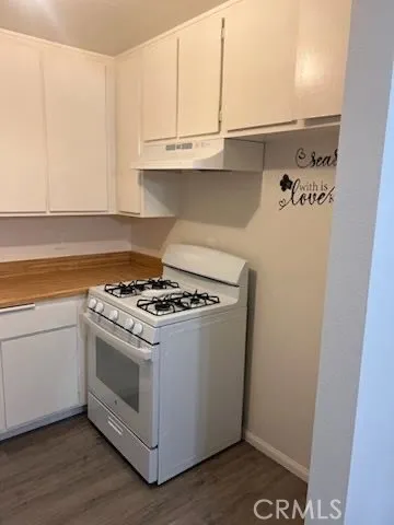 a stove top oven sitting inside of a kitchen