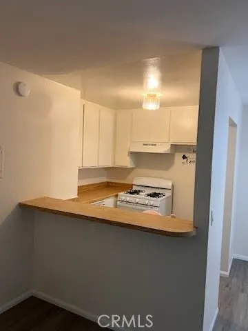 a kitchen with a sink a stove and cabinets