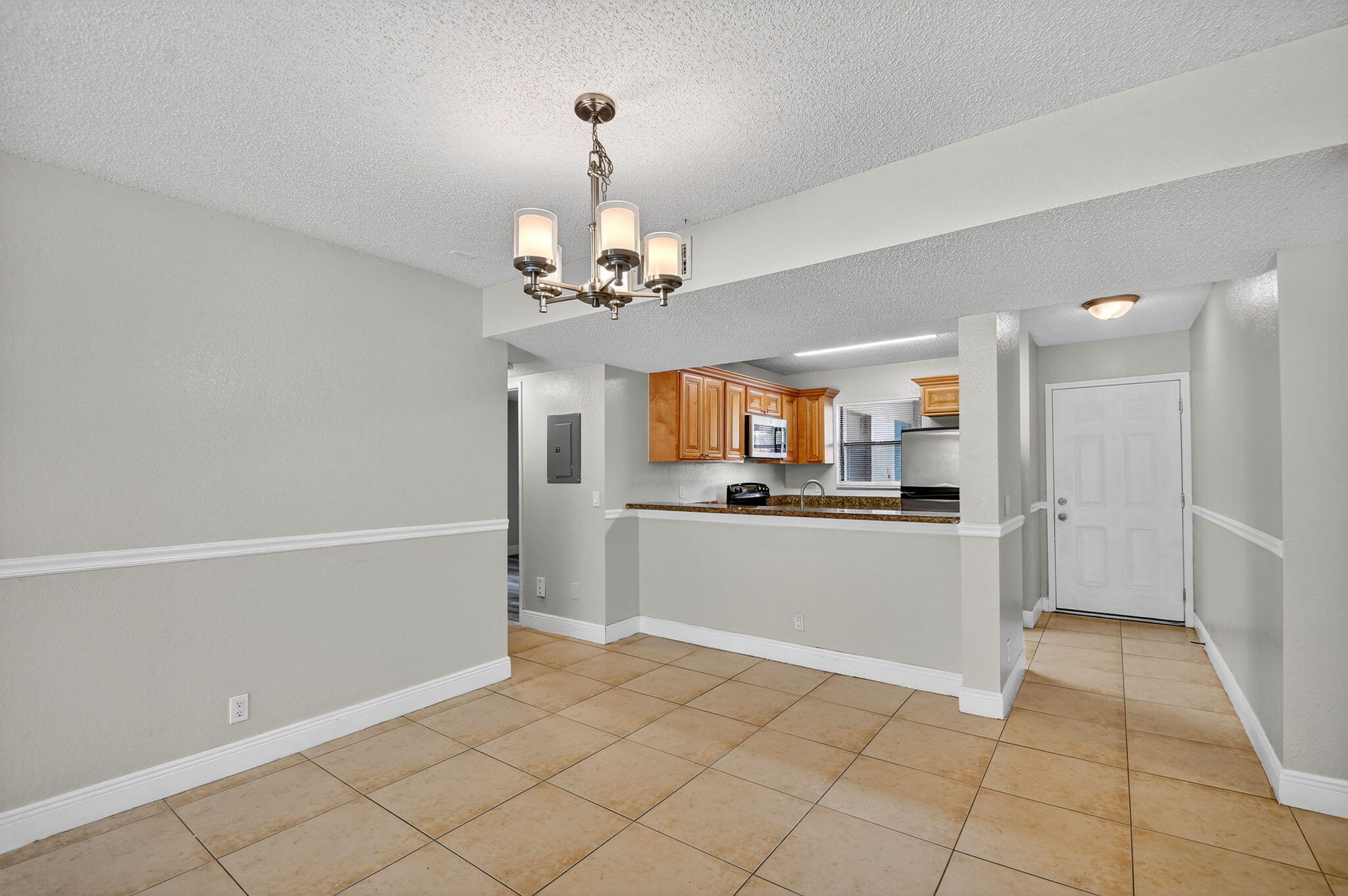 1601 Windorah Way, Unit D West Palm Beach, FL 33411 - Photo 28 of 41 a view of a kitchen with refrigerator and cabinets