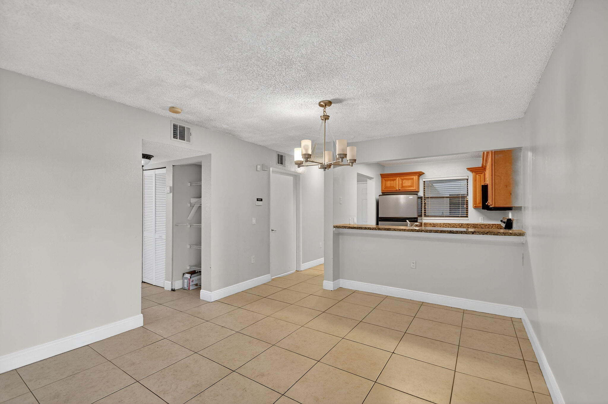 1601 Windorah Way, Unit D West Palm Beach, FL 33411 - Photo 35 of 41 a view of a kitchen with a sink dishwasher a refrigerator and a view of kitchen