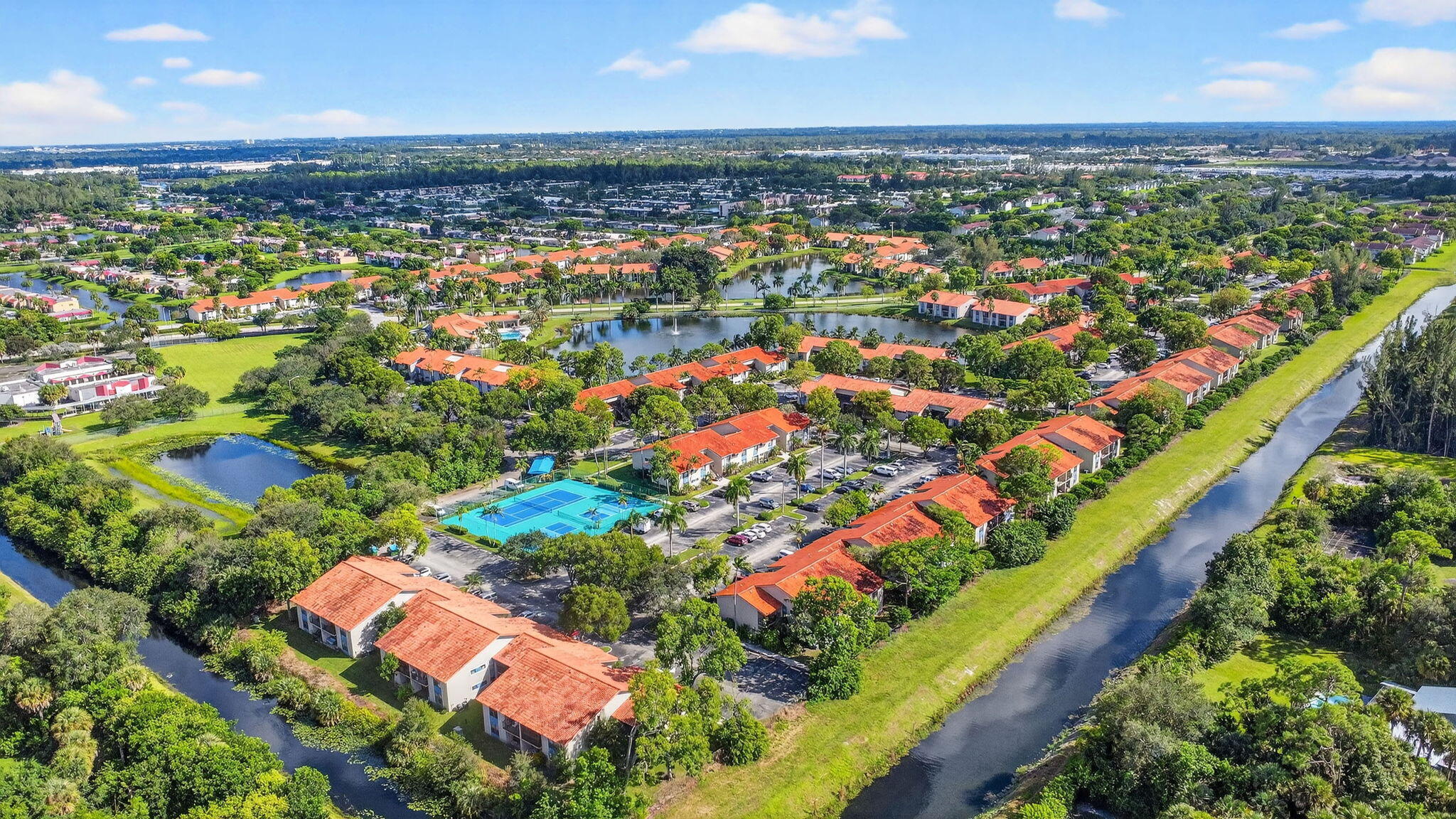 1601 Windorah Way, Unit D West Palm Beach, FL 33411 - Photo 8 of 41 an aerial view of residential houses with outdoor space and trees