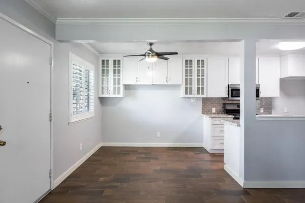 a view of a kitchen with refrigerator and cabinet