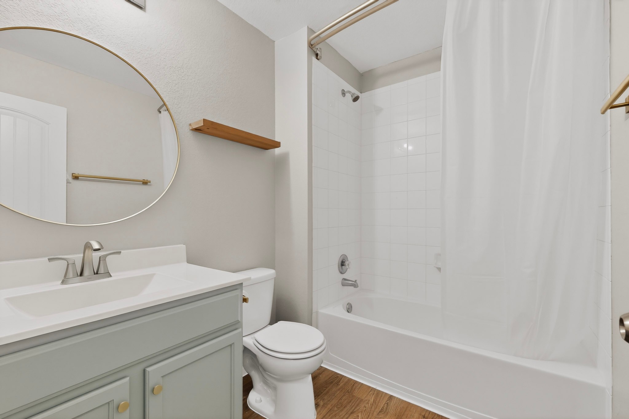 14513 Esker Road Manor, TX 78653 - Photo 21 of 38 A well-appointed bathroom features a single vanity, modern toilet, and a pristine bathtub with shower.