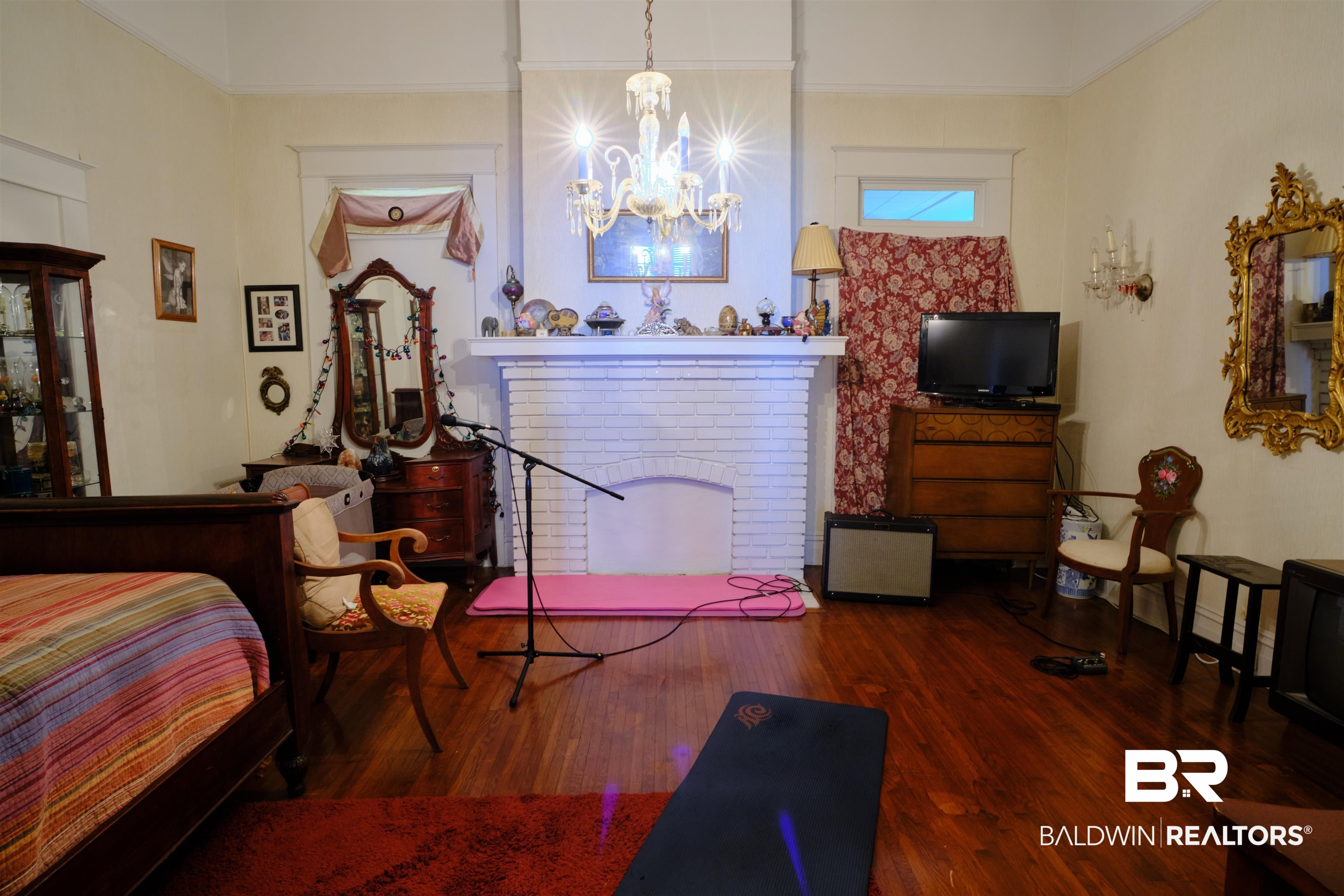 101 West Horner Street Atmore, AL 36502 - Photo 17 of 38 Bedroom featuring hardwood / wood-style flooring and a notable chandelier