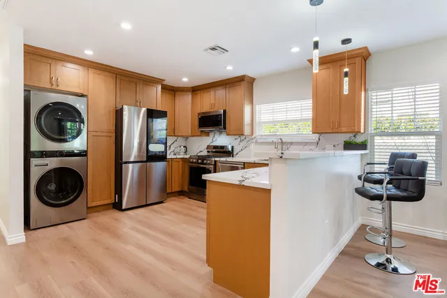 a kitchen with stainless steel appliances granite countertop a refrigerator sink and cabinets