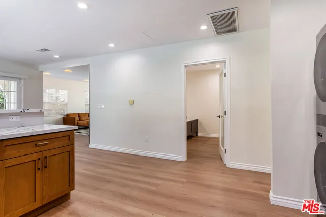 a view of a kitchen cabinets and wooden floor