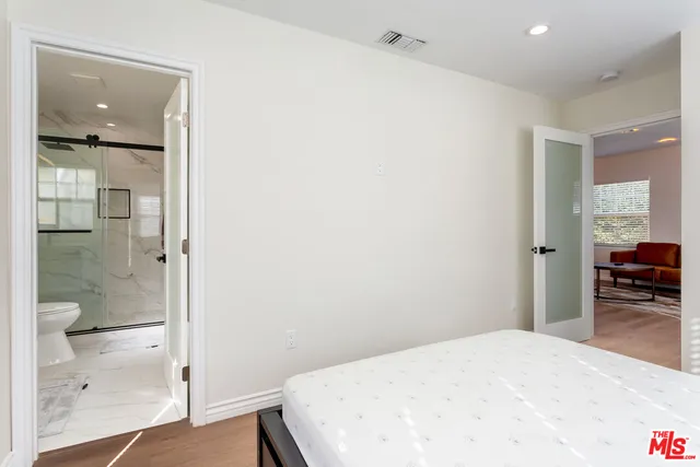 a bedroom with a bed and a view of bathroom