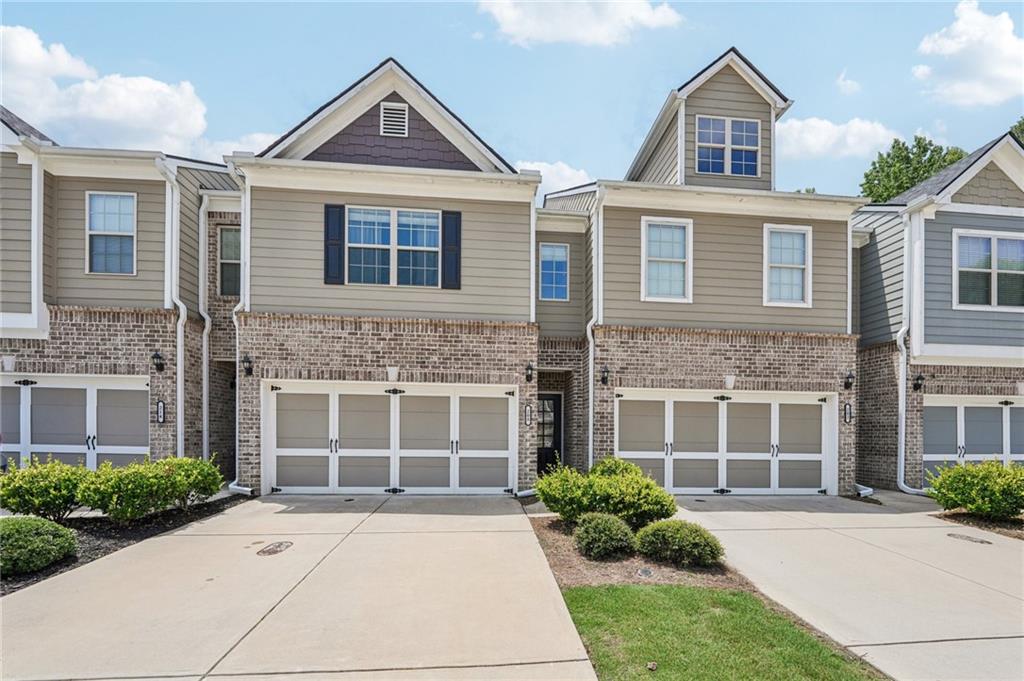 208 Trailside Way Hiram, GA 30141 - Photo 1 of 45 a front view of a house with yard and parking