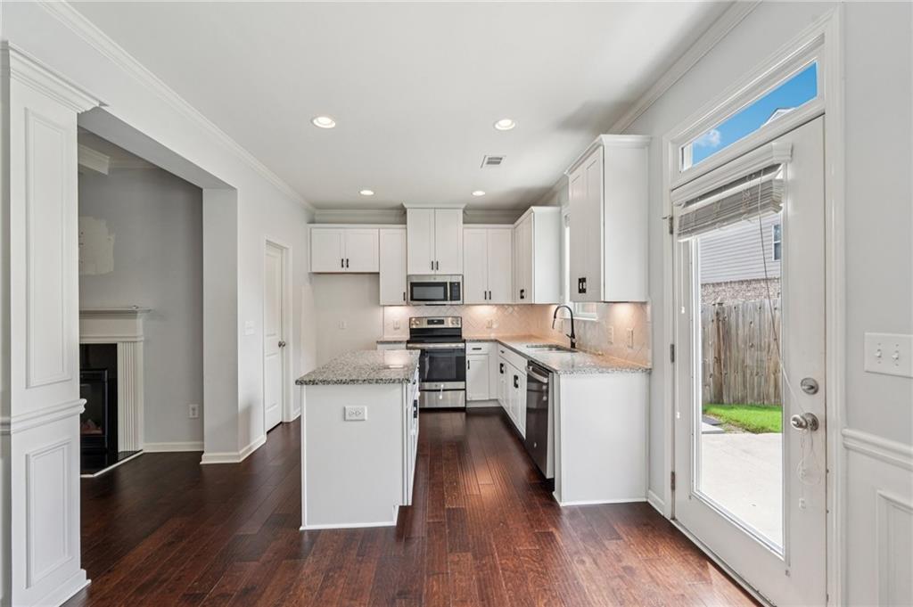 208 Trailside Way Hiram, GA 30141 - Photo 12 of 45 a kitchen with a refrigerator a stove top oven and wooden floor