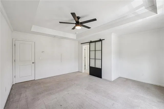 a bathroom with a granite countertop double vanity sink a mirror and a bathtub