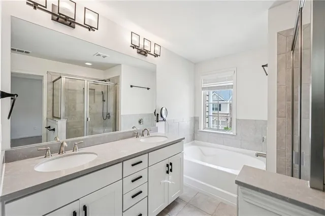 a bathroom with a granite countertop sink mirror and a shower