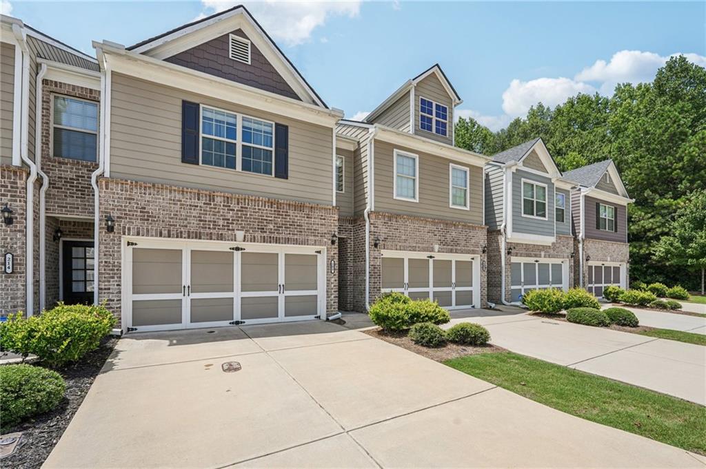 208 Trailside Way Hiram, GA 30141 - Photo 3 of 45 a front view of a house with a yard and potted plants