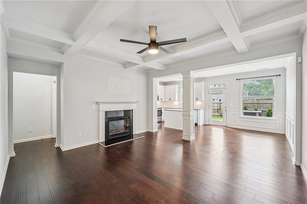 208 Trailside Way Hiram, GA 30141 - Photo 5 of 45 an empty room with wooden floor fireplace and windows