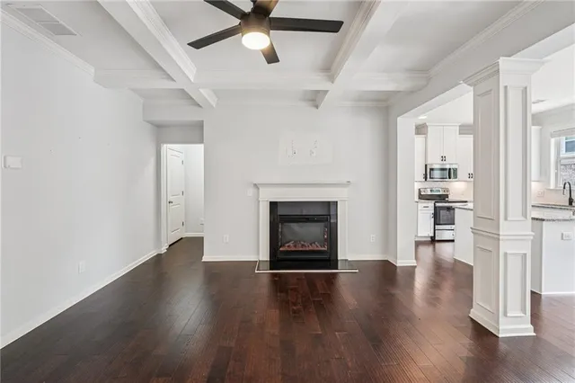 a view of a livingroom with wooden floor and a fireplace
