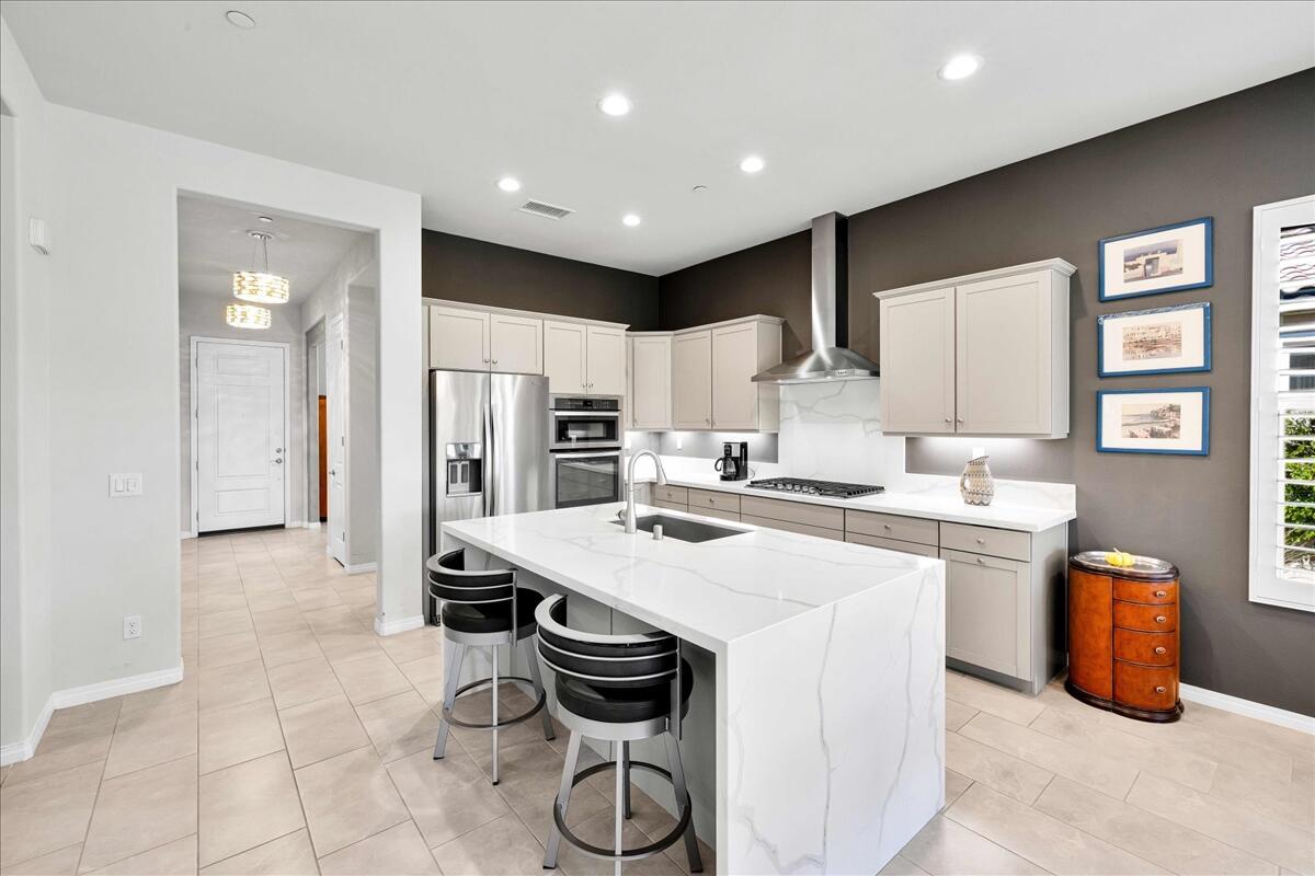 57 Syrah Rancho Mirage, CA 92270 - Photo 17 of 50 a kitchen that has a lot of cabinets in it and appliances