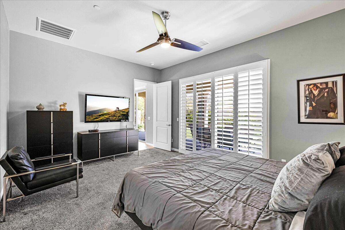 57 Syrah Rancho Mirage, CA 92270 - Photo 20 of 50 a bedroom with a bed and a flat screen tv