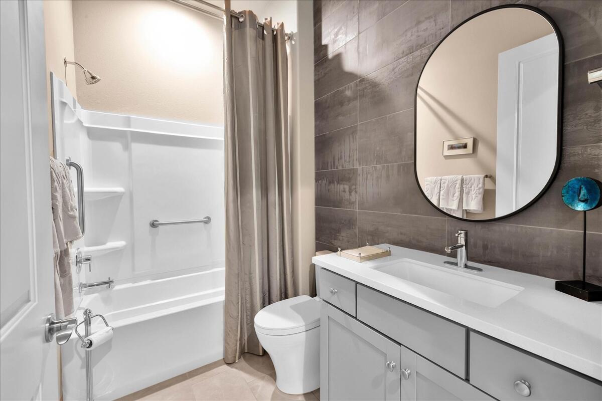 57 Syrah Rancho Mirage, CA 92270 - Photo 24 of 50 a bathroom with a sink a toilet and a mirror