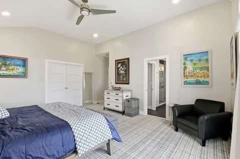 a bedroom with a bed and ceiling fan