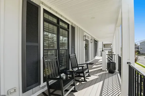 a view of balcony with floor to ceiling windows and wooden floor