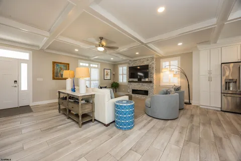 a kitchen with lots of wooden furniture appliances and dining table