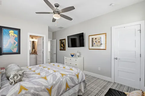 a large white kitchen with stainless steel appliances kitchen island a stove a sink a oven and a dining table with wooden floor