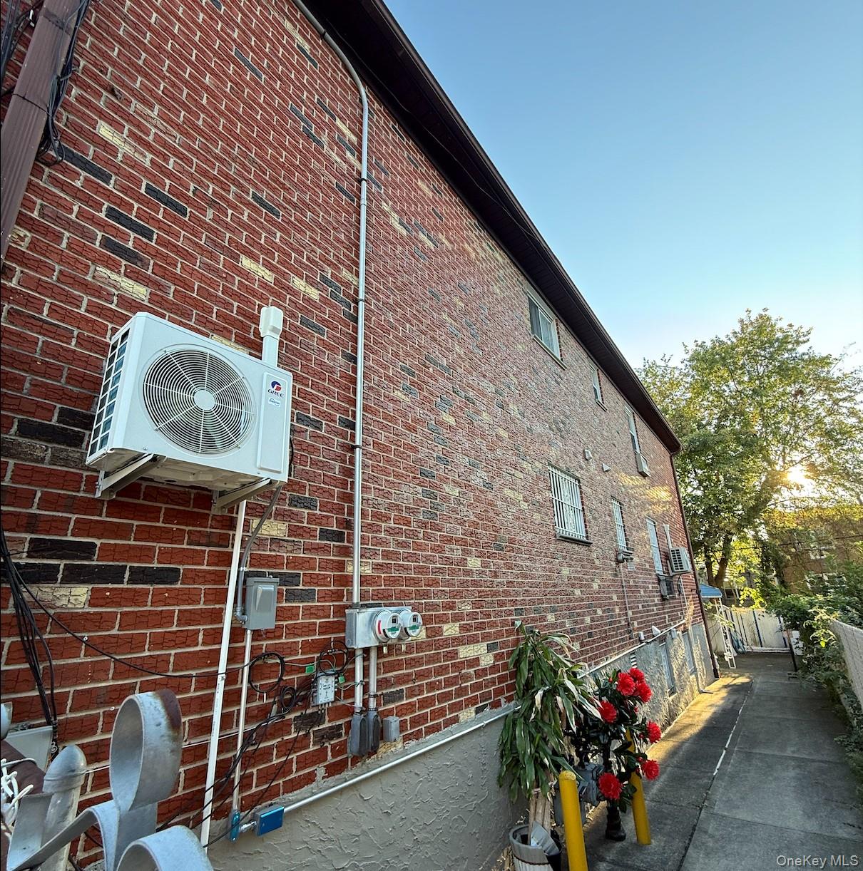 43-24 163rd Street Queens, NY 11358 - Photo 12 of 12 View of side of property featuring an ac unit and brick siding