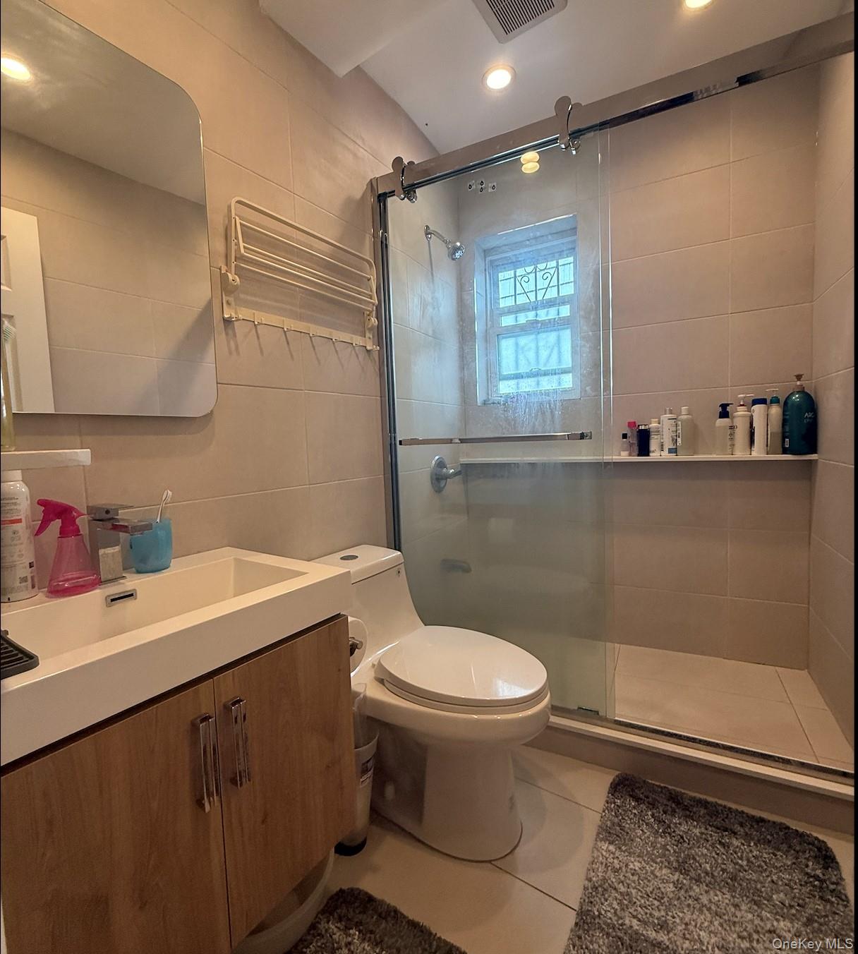 43-24 163rd Street Queens, NY 11358 - Photo 3 of 12 Full bathroom with tile walls, a shower stall, vanity, tile patterned flooring, and recessed lighting
