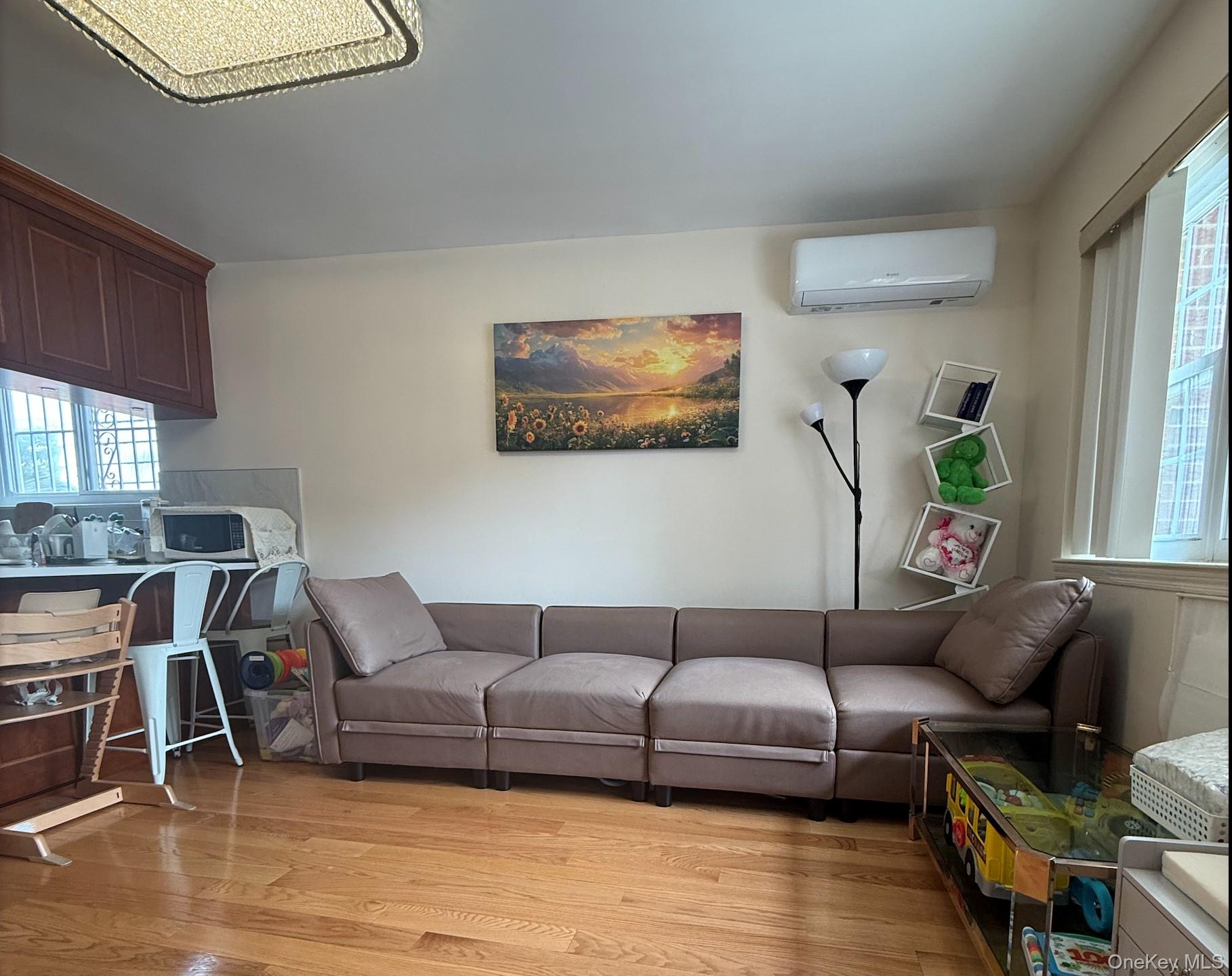 43-24 163rd Street Queens, NY 11358 - Photo 7 of 12 Living room with light wood-style flooring and a wall mounted air conditioner