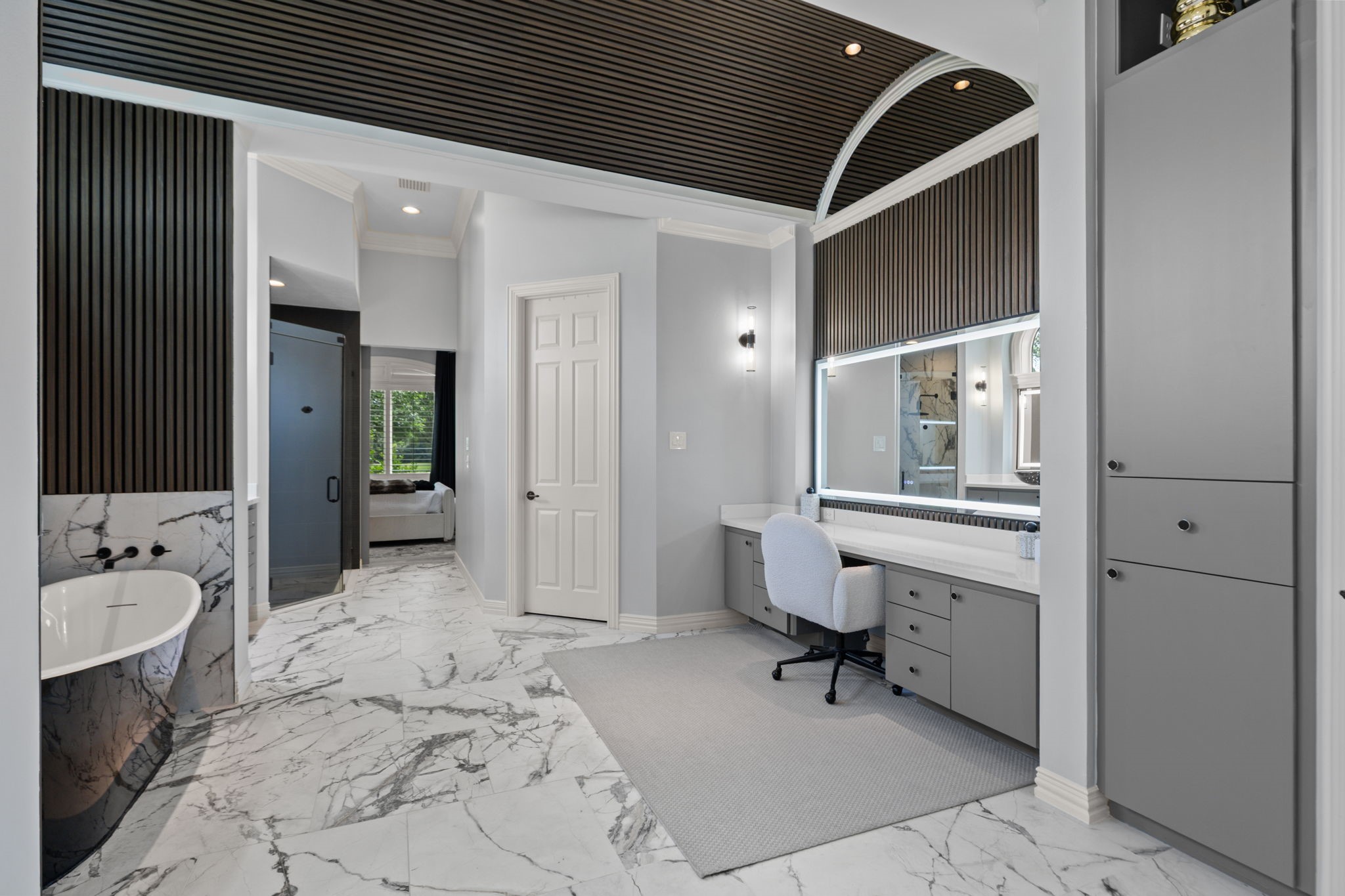 39 Maymont Way Spring, TX 77382 - Photo 23 of 50 This modern bathroom features elegant marble flooring, a freestanding bathtub, and a spacious vanity area with ample storage. The sleek design is complemented by a stylish ceiling and contemporary lighting.