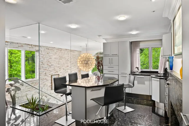 a room with lots of potted plants and wooden floor