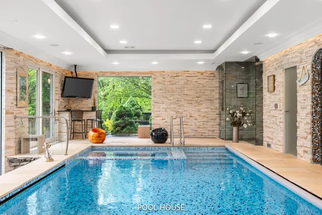 a front view of a house with a yard and plant