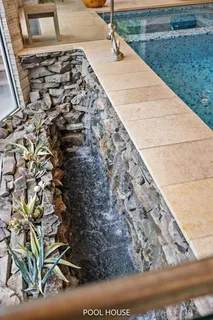 aerial view of a house with backyard porch and sitting area