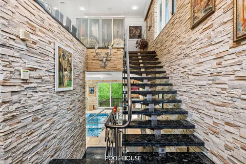 a kitchen that has a lot of cabinets a sink and appliances