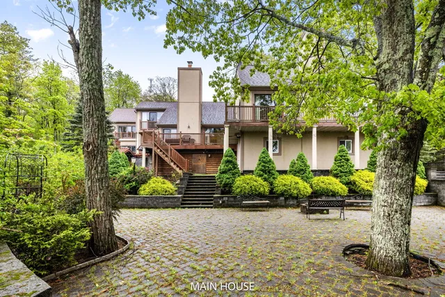 a bedroom with a bed and lamp on desk