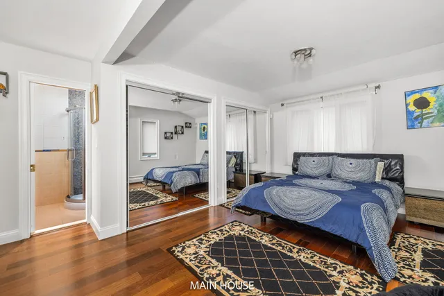 a view of a hallway with a dining table and chairs